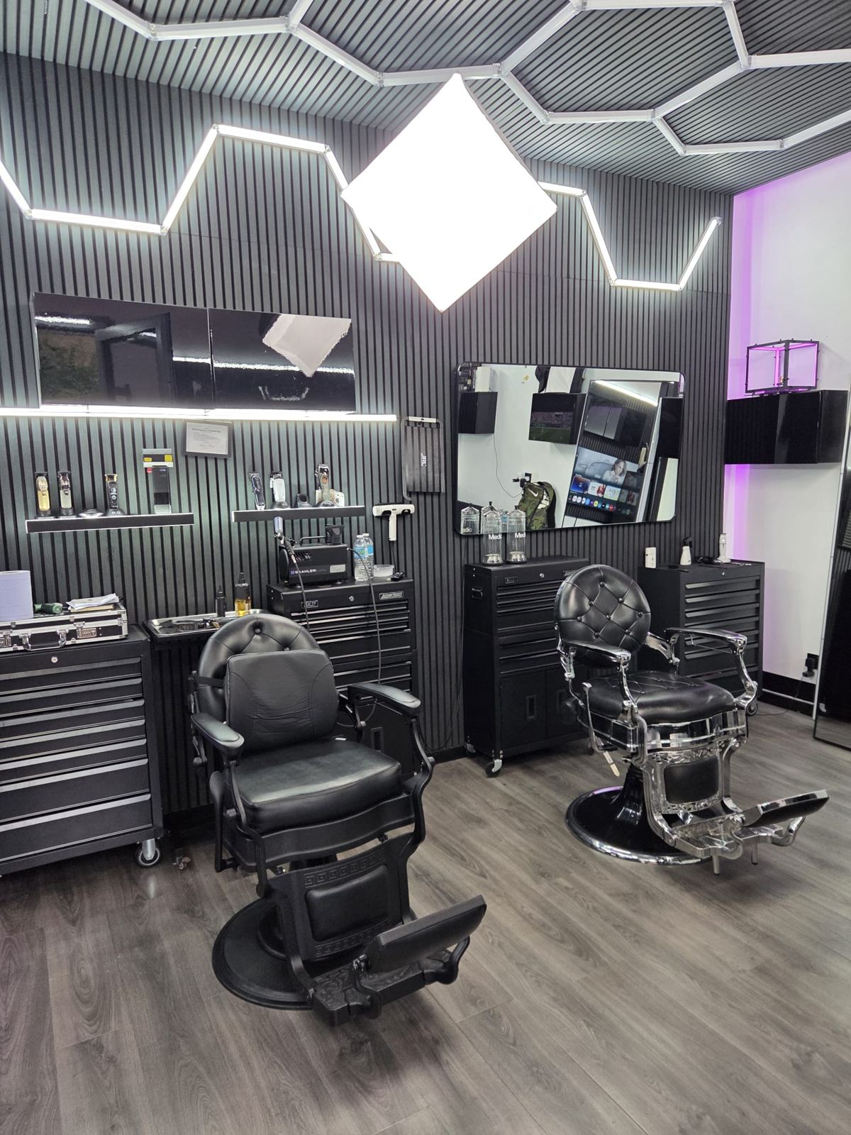 Two barber chairs facing the mirrors